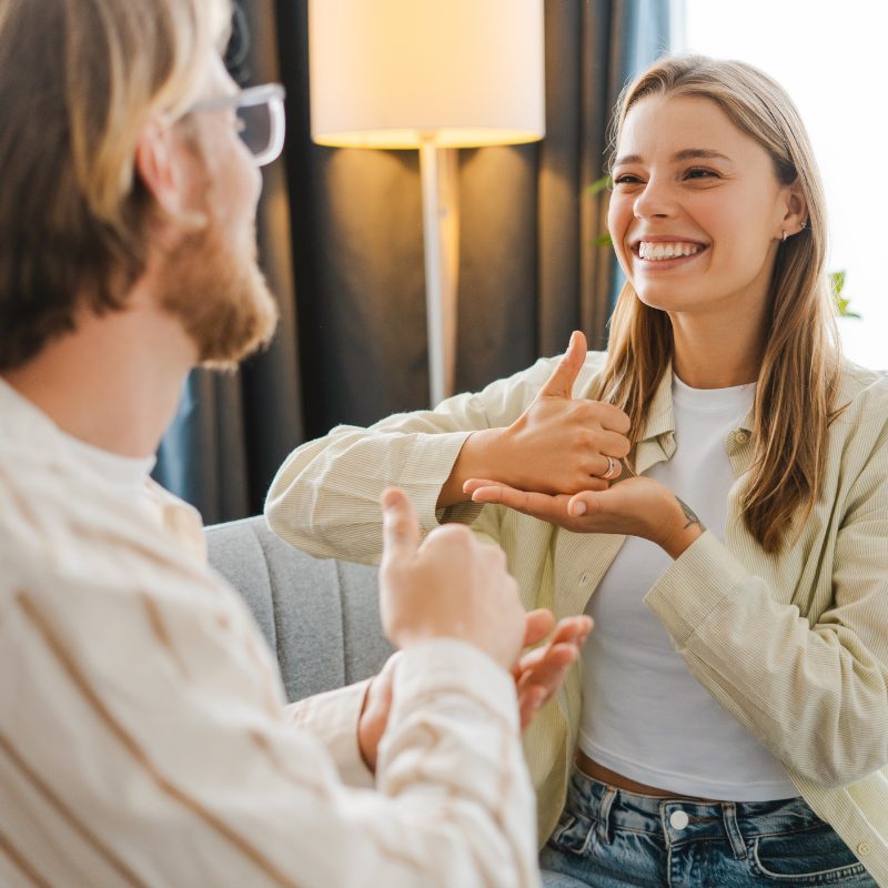 Two people communicating in conversation, facing each other